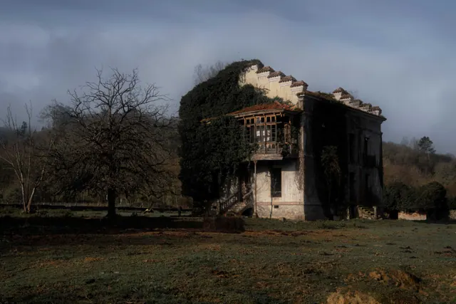 Casa antigua cerrada en un pueblo español, con las persianas bajadas