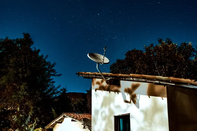 Antena parabólica de internet por satélite instalada en el tejado de una vivienda rural