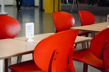 Sillas rojas y mesas de madera en una cafetería