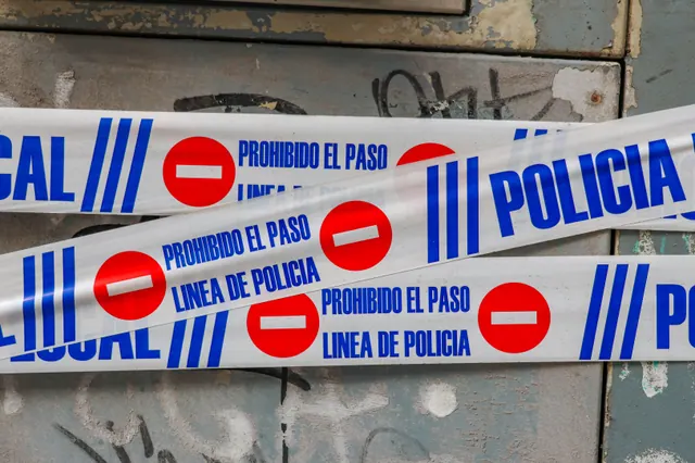 Cinta policial de "prohibido el paso" cruzada sobre una puerta