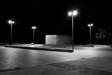 Plaza vacía iluminada por farolas durante la noche
