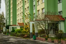 Bloque de viviendas con entradas ajardinadas en una calle residencial