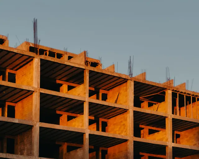 Edificio en construcción con estructura de hormigón al atardecer