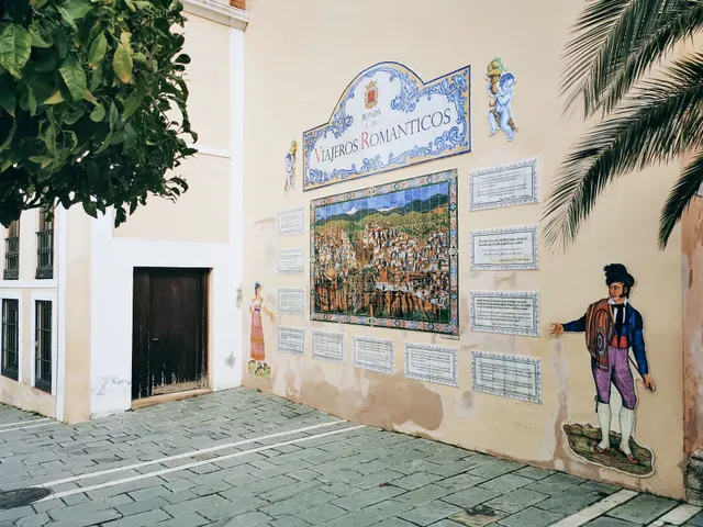 Mural cerámico de la Ronda de los Viajeros Románticos en una fachada
