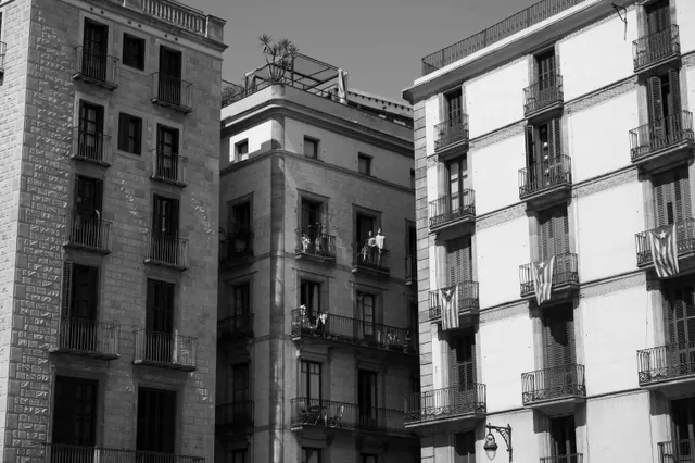 Fachadas de edificios antiguos con banderas colgadas en los balcones