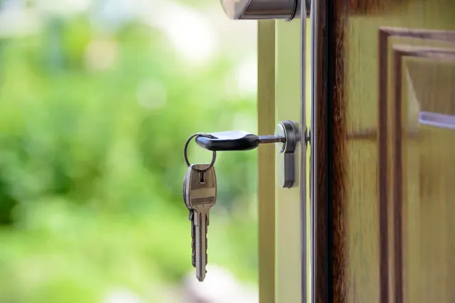 Llaves puestas en la cerradura de una puerta de madera