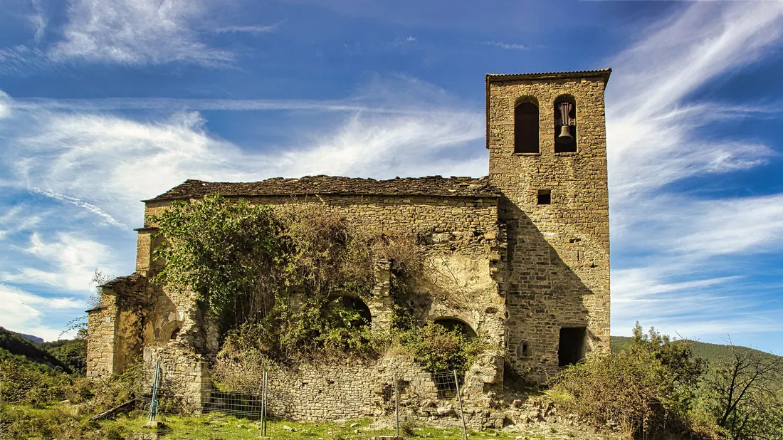 Antigua iglesia de piedra en ruinas con torre campanario